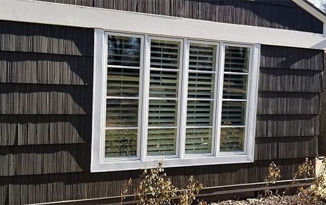 outdated casement windows on a wood-sided Kansas home