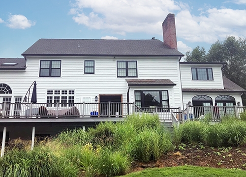 Backyard view of a New Hope colonial style home with updated windows and doors.