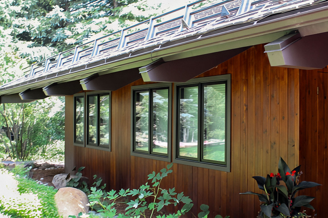 Aspen Energy Efficient home with wood siding and black-trimmed windows.