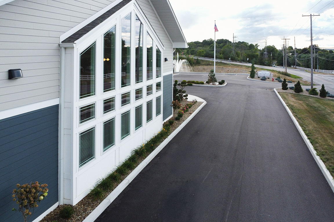 Exterior view of a commercial building with large vertical windows.