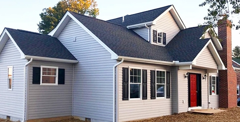Curbside view of Stewartstown home illustrating whole-home transformation with replacement windows.