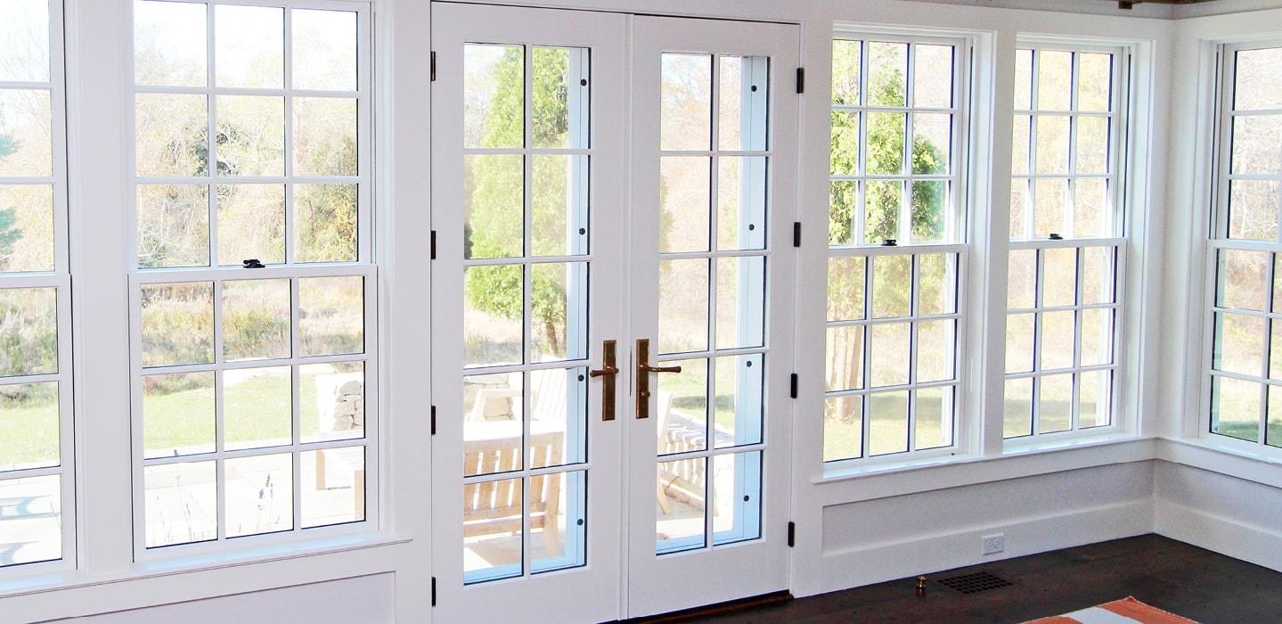 white hinged patio doors surrounded by white windows