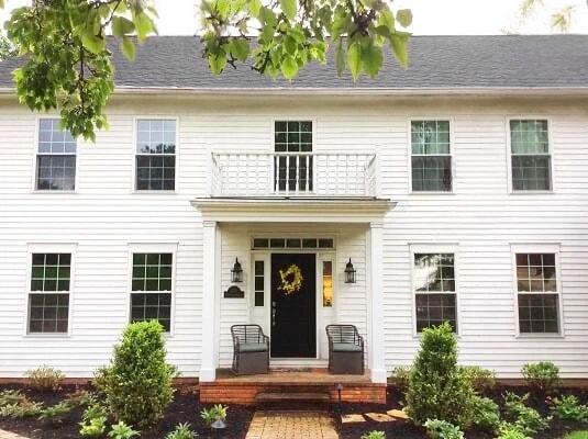 Front view of traditional Columbus home with newly installed Pella vinyl double-hung windows.