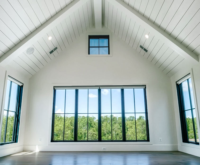 Interior view of aluminum-clad windows and doors in a modern Charlottesville farmhouse.