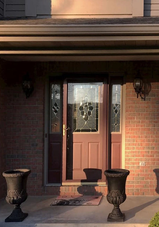 Entryway to Pittsburgh home with outdated front door.