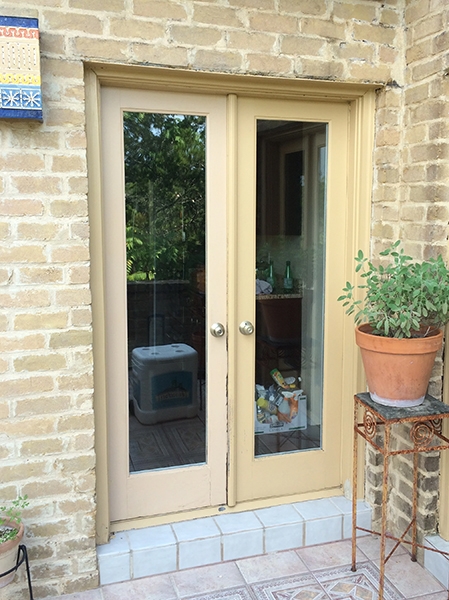 Closeup view of outdated patio door on San Antonio home.