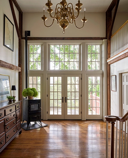 Entryway lined with white windows on wall.