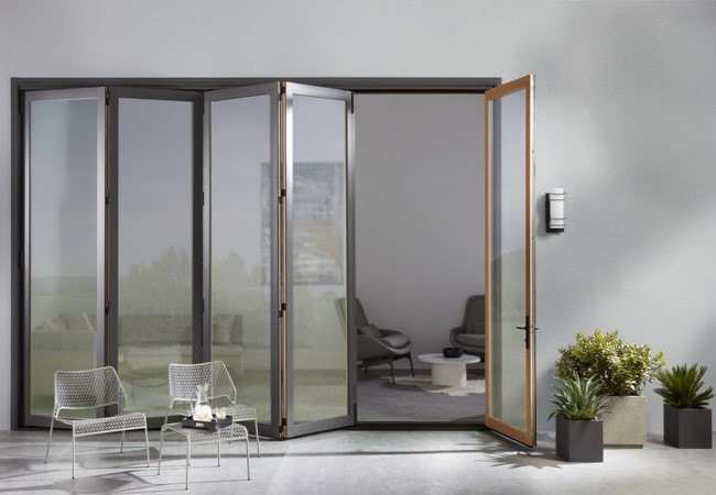 Contemporary bifold door opens space between patio and living room