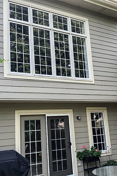 A window combination of four awnings over four casement windows, all with traditional grilles.