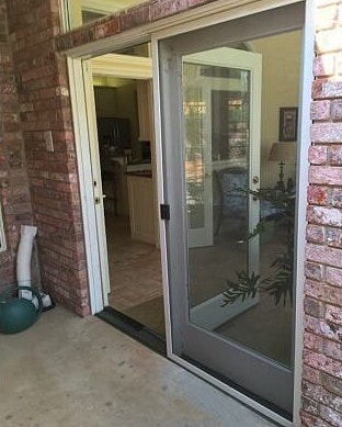 Wood french doors on a brick home