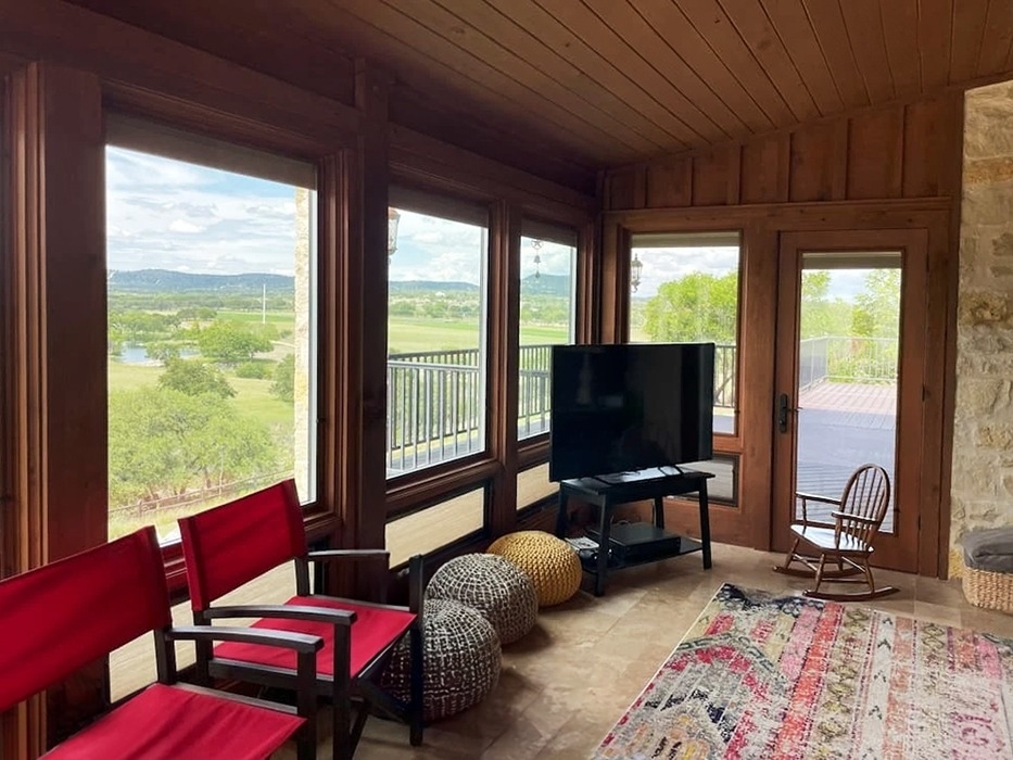  Interior view of Bandera sunroom with floor to ceiling Pella windows.