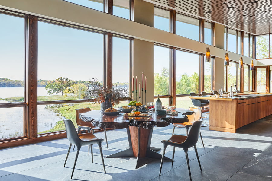 Wood frame windows behind dining table with lake view