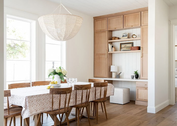 a standard dining room table with an extra-large light fixture overhead