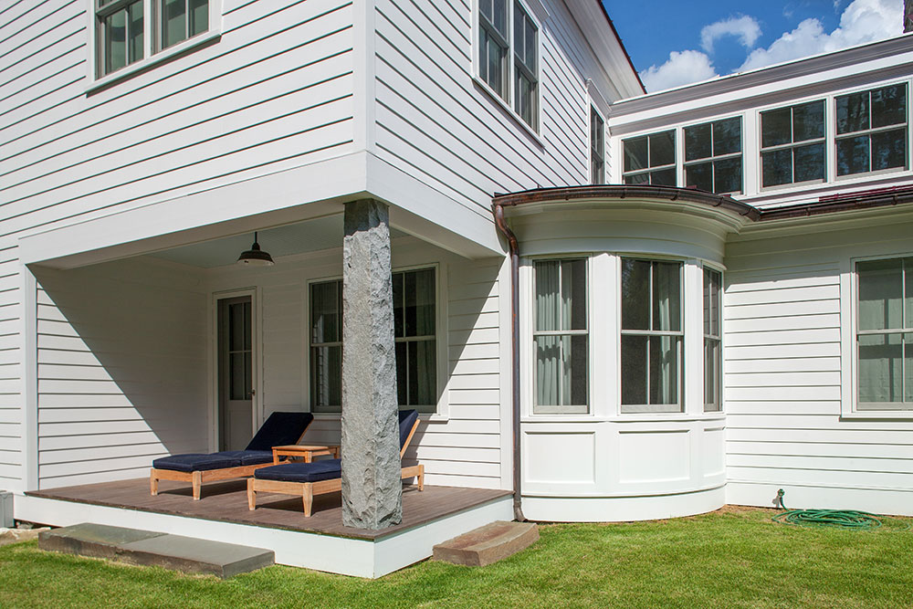 Backyard view of Berkshire home with newly installed curved double hung windows.