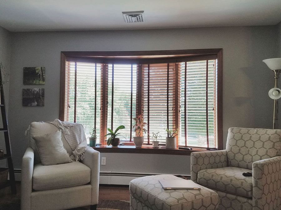 Before image of a wood bow window with blinds