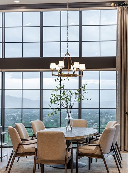 A window wall provides a scenic view to this Apline, Utah dining room