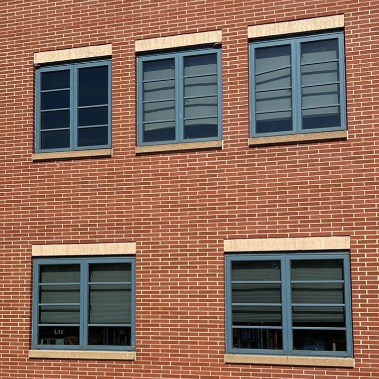 Before image of old, drafty aluminum windows.
