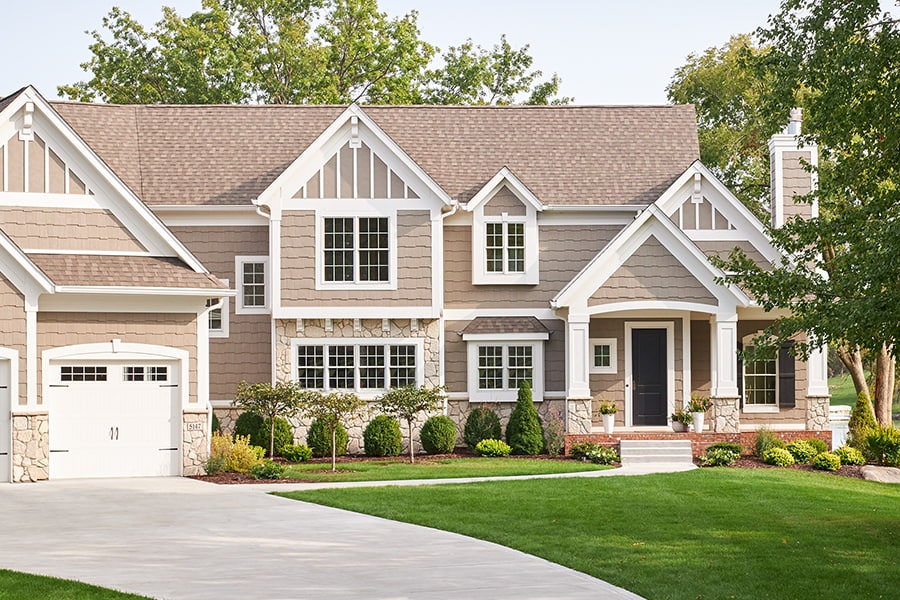 large traditional home with window grids on both the windows and garage door