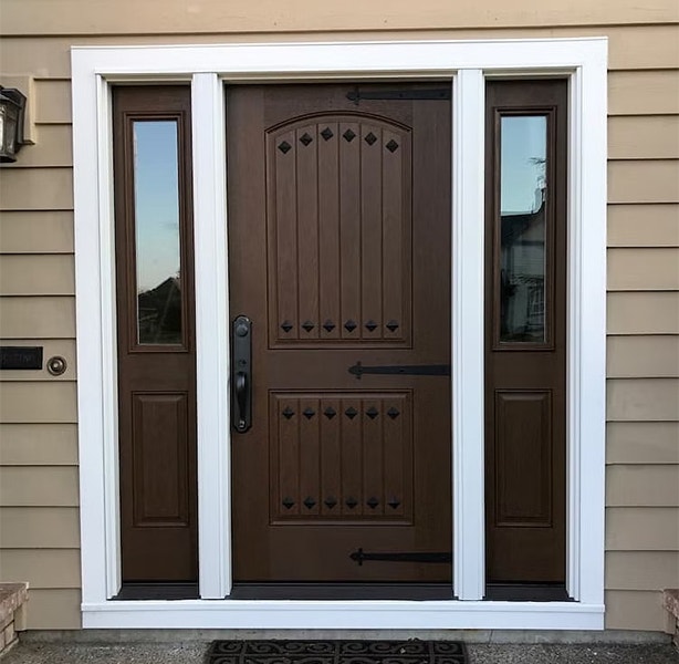A Pella solid fiberglass front door with decorative elements and 1/2 light sidelights.