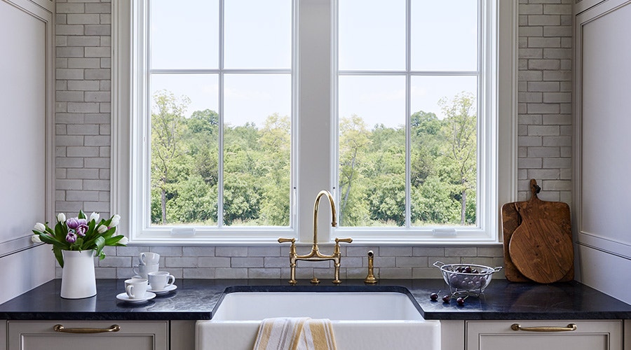 two casements over a black kitchen counter