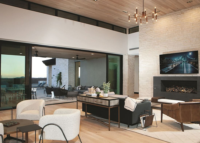 Scottsdale, Arizona home interior living room and a newly installed multi-slide door that opens to a stone patio