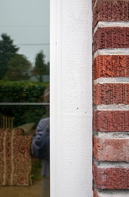 a close-up photo of a new window sash on a brick home