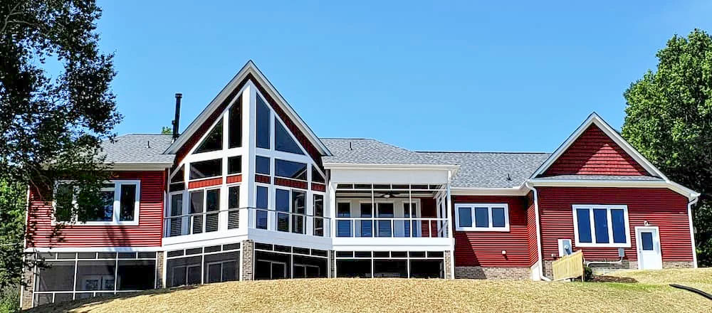 Backyard view of Midlothian home with newly installed custom white windows.
