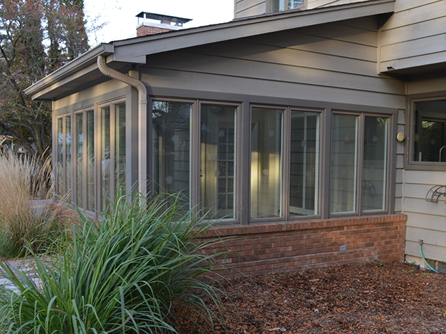 Before sunroom windows overlooking patio. 