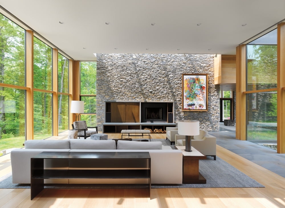 Wood Windows Create Walls Of Glass For Modern Living Room Modern living room with stone wall in the front surrounded by walls fixed wood windows on either side