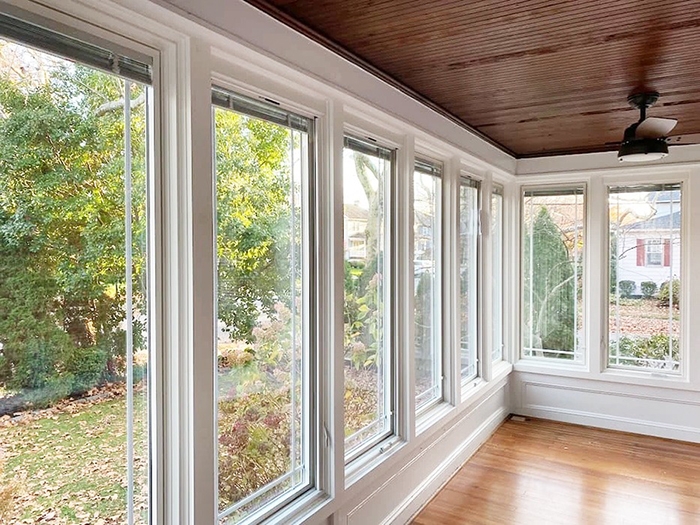  Interior view of Haddonfield sunroom showcasing casement windows with retractable screens maximizing ventilation and natural light.