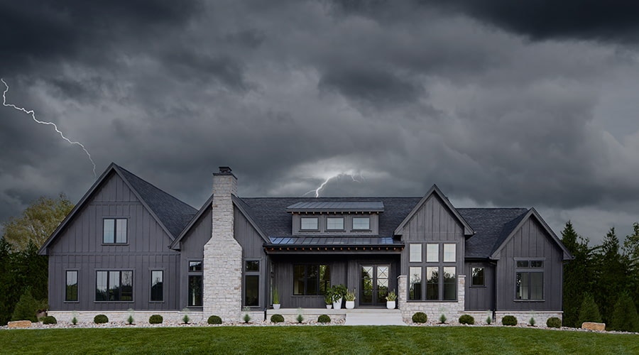 dark, stormy clouds behind a gray home exterior