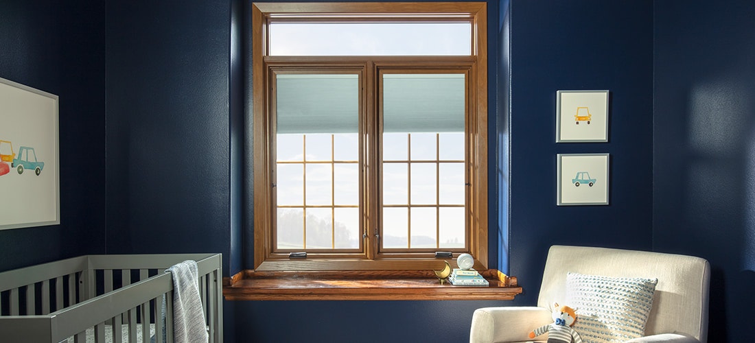 two wood lifestyle series windows in a dark blue nursery