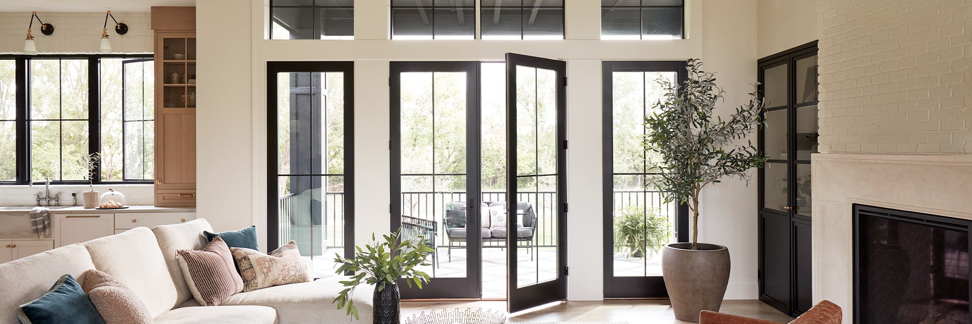 two hinged patio doors open from the living room to a deck