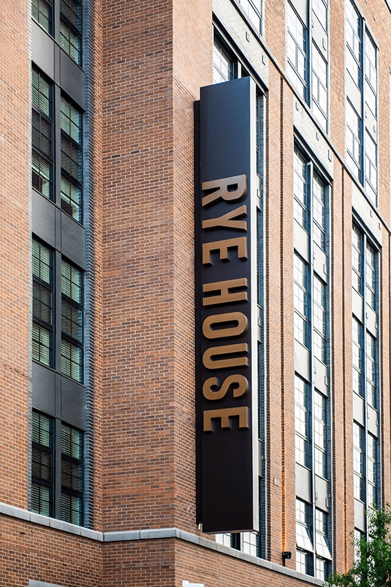 Black picture windows on exterior of luxury apartment complex in Baltimore. 