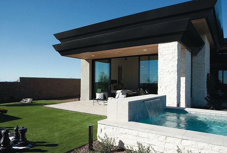 Scottsdale, Arizona home exterior backyard with a small pool and green grass