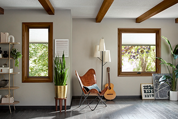A music room styled with wood beams and wood windows that also include blinds between-the-glass.