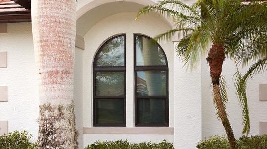 a two-side arched set of double-hung windows on a coastal home