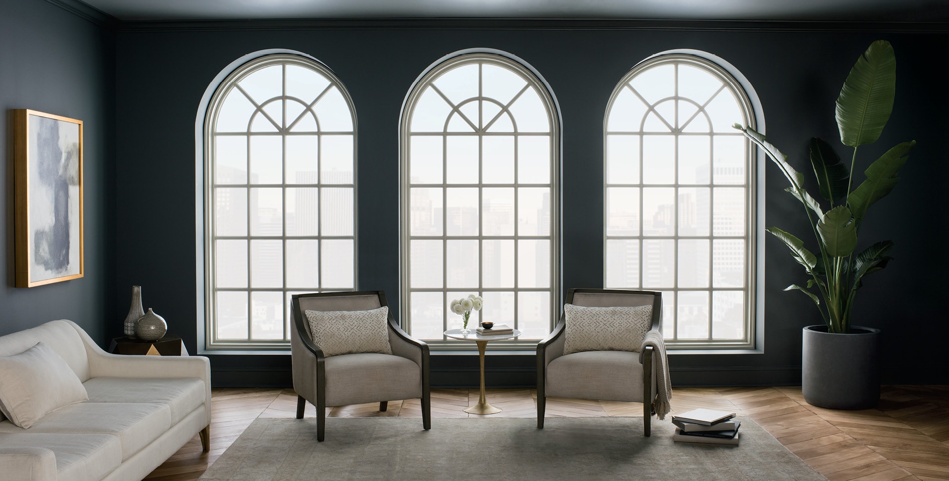 living room with dark-painted walls and three arched custom wood pella windows