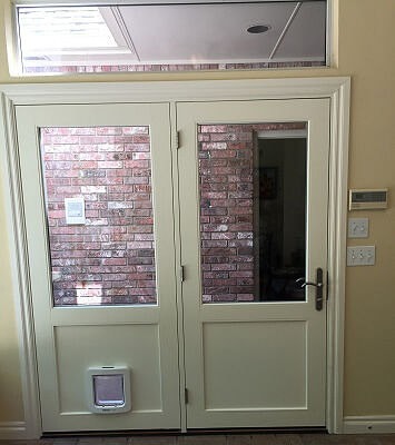 the interior view of fixed and hinged door that includes a doggy door