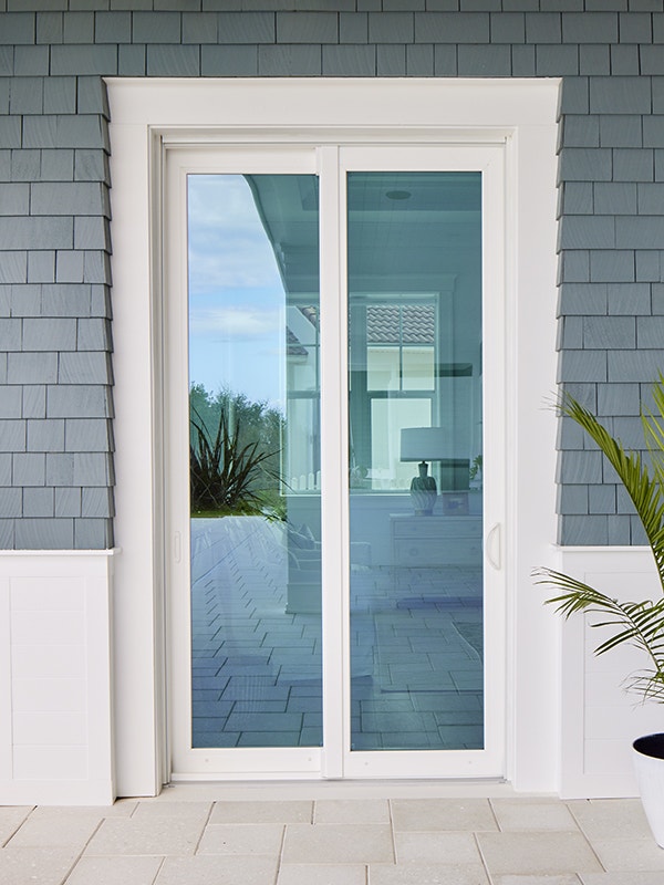 White double hinged patio door with red tiled steps and silver handles