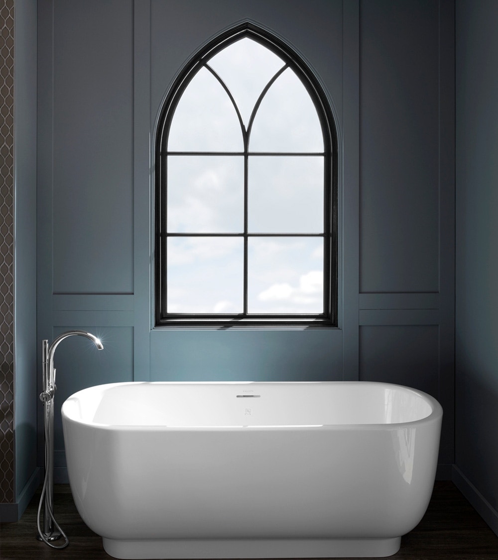 dark gray bathroom walls, white freestanding tub, and black custom shape window overhead