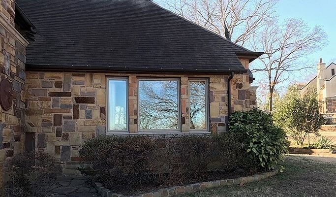 Two casement and one fixed window on a Tulsa brick home exterior