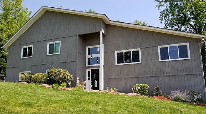 Roanoke home with white vinyl windows on a gradually sloping yard