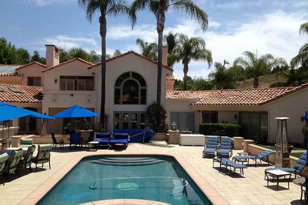A large home in Orange County, California has a large courtyard which shows the custom windows installed.