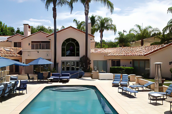 A large home in Orange County, California has a large courtyard which shows the custom windows installed.