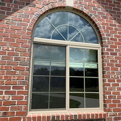  A sliding window with an arched transom is ready for a remodel.