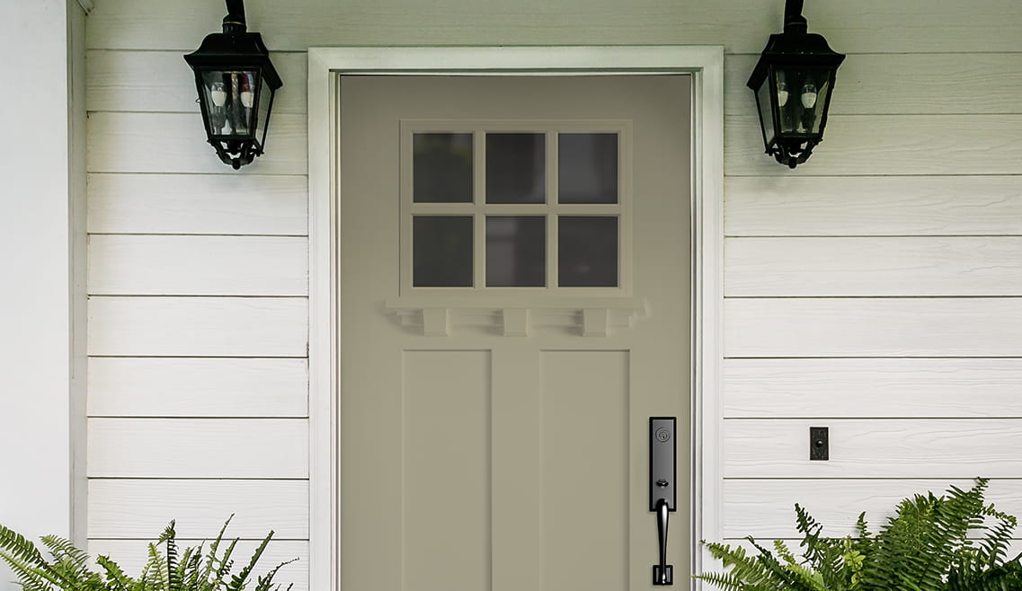 A fiberglass craftsman light front door with a dentil shelf as a decorative element