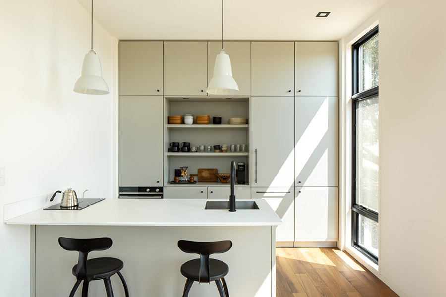 White kitchen with black triple pane windows