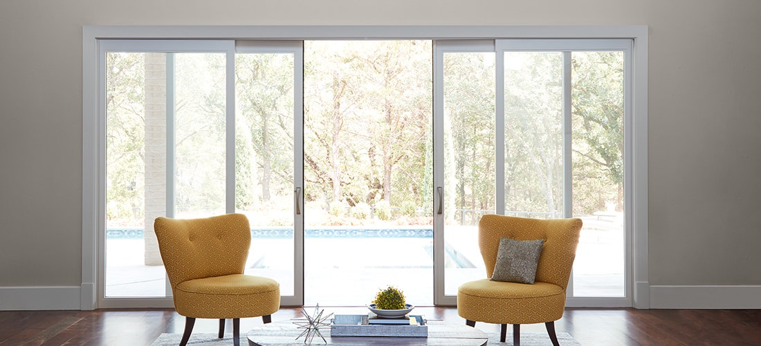 two orange contemporary chairs in front of a lifestyle four-panel sliding patio door
