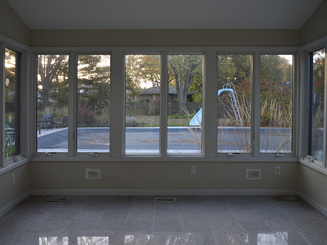 Before interior sunroom windows overlooking pool area.
